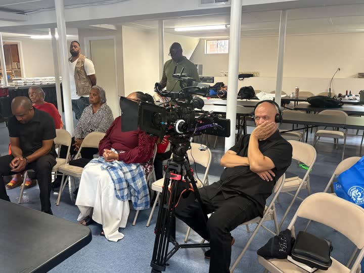 Camera operator setting up a shot in the church hall