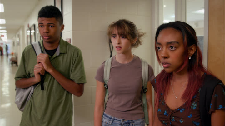 Three people stand together
